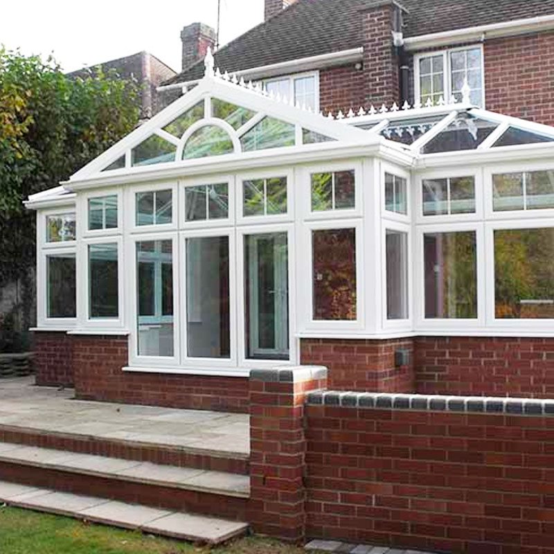 white uPVC combination conservatories Newbury with steps to garden and small wall
