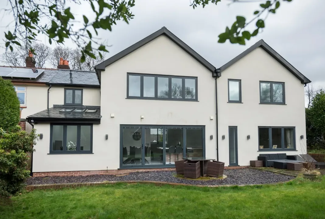 Grey uPVC flush casement windows fitted to a modern rendered home