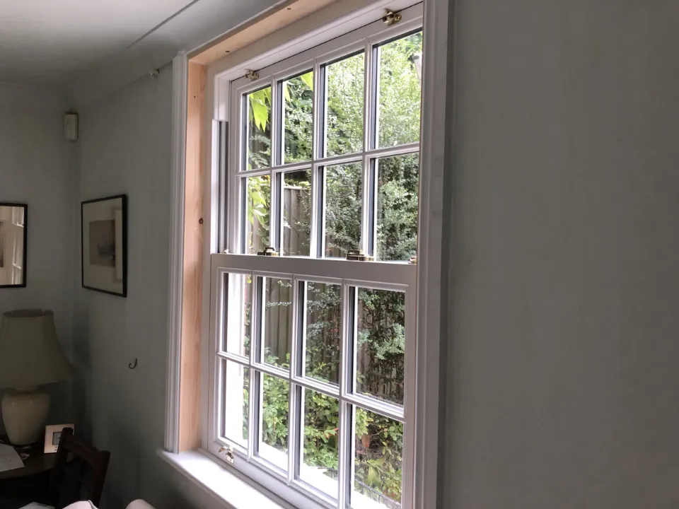 Interior view of a white uPVC sliding sash window with Georgian bars
