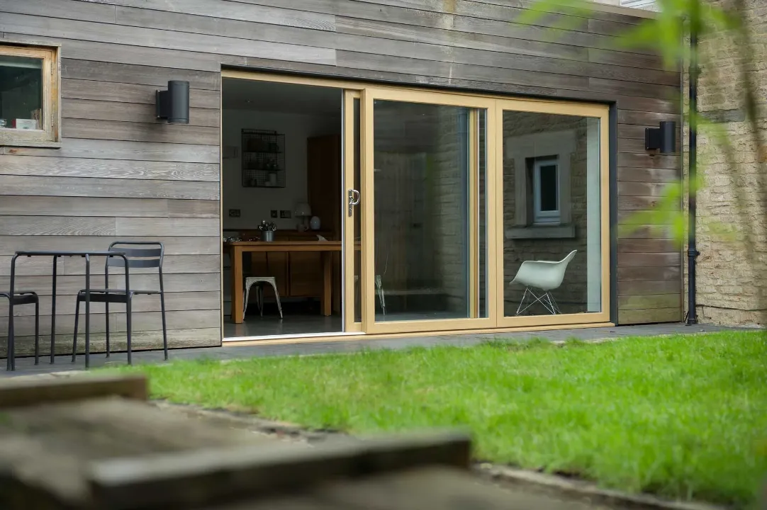 Wood-effect uPVC sliding patio doors opened onto a garden